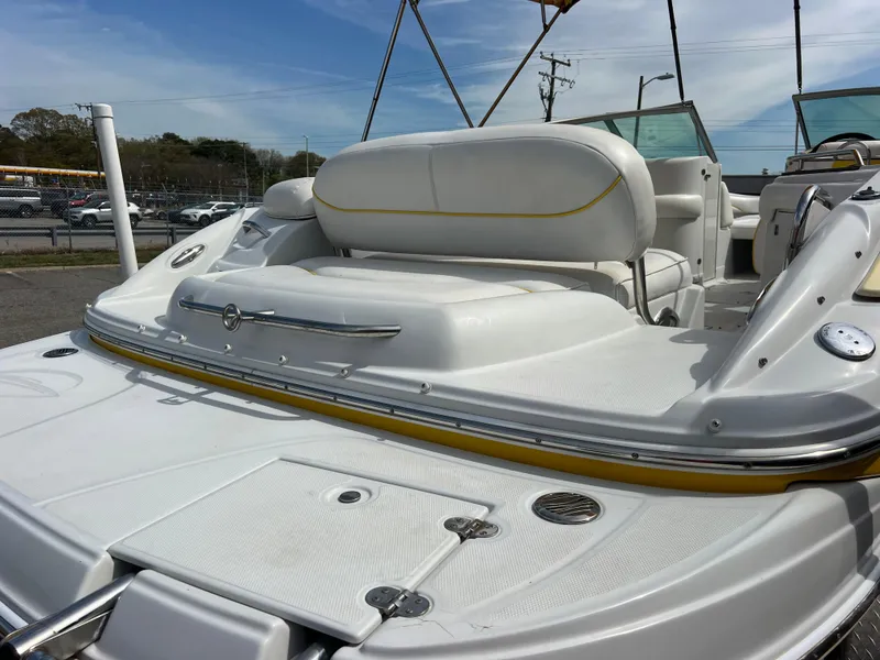 Slide: The Image of 2006 Crownline 240 EX boat, white interior, spacious seating, outdoor setting, clear sky background. - 6