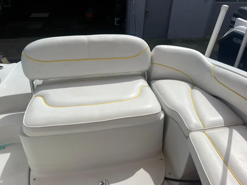 Slide: The Image of 2006 Crownline 240 EX boat seating with white upholstery and yellow accents. - 9
