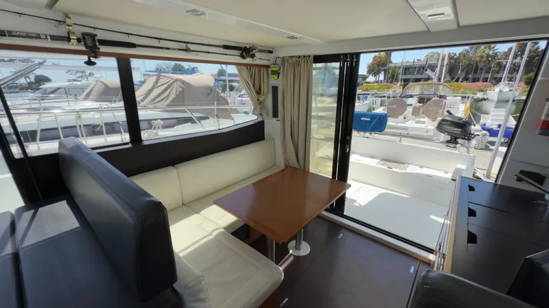 Slide: The Image of Interior of 2016 Jeanneau Velasco 37F yacht with seating and table, marina view. - 12
