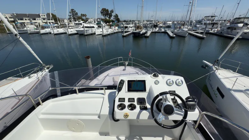 Slide: The Image of Flybridge view of 2016 Jeanneau Velasco 37F yacht docked in a marina. - 15