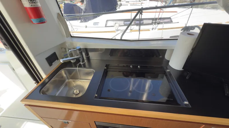 Slide: The Image of Jeanneau Velasco 37F 2016 yacht kitchen with sink and stove, featuring modern design. - 17