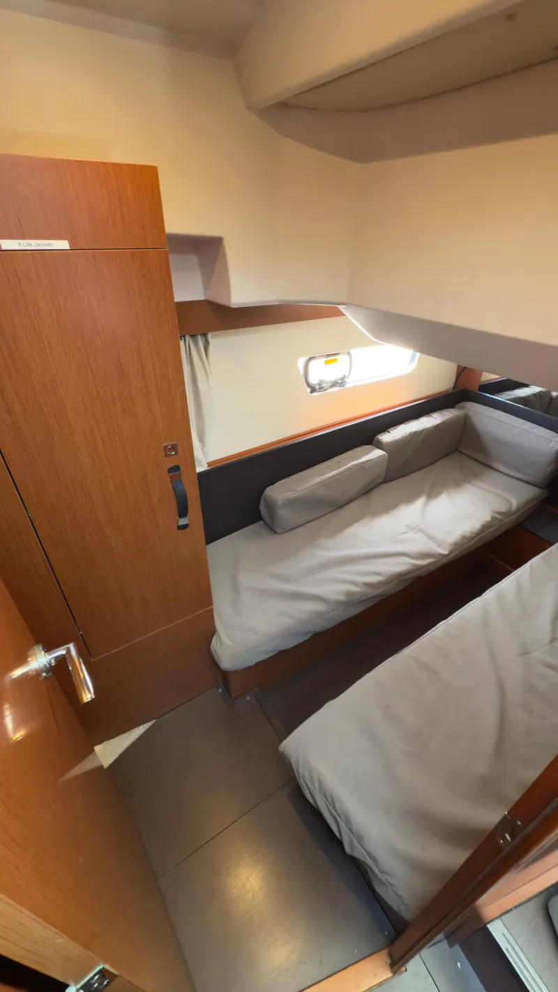 Slide: The Image of 2016 Jeanneau Velasco 37F cabin interior with twin beds and wooden finish. - 25