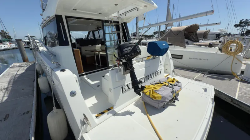 Slide: The Image of 2016 Jeanneau Velasco 37F yacht docked at marina, rear view with outboard motor. - 3