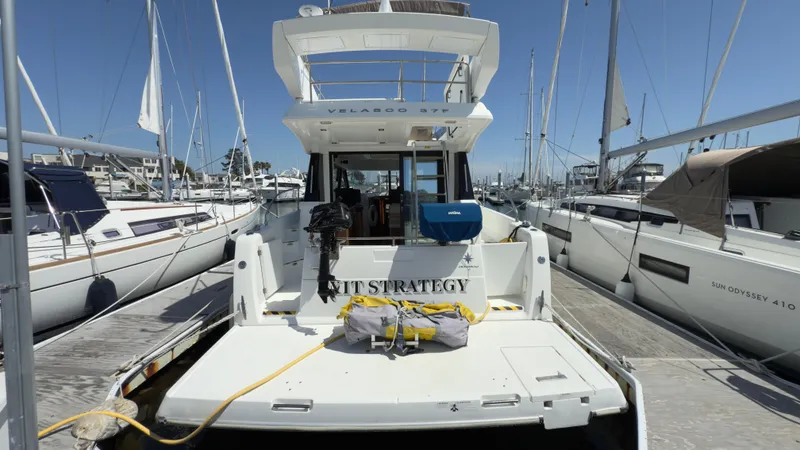 Slide: The Image of 2016 Jeanneau Velasco 37F yacht docked at marina, surrounded by sailboats. - 4