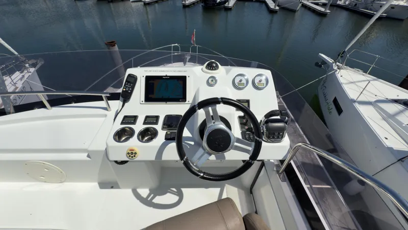 Slide: The Image of Helm of 2016 Jeanneau Velasco 37F yacht with steering wheel and navigation controls. - 7