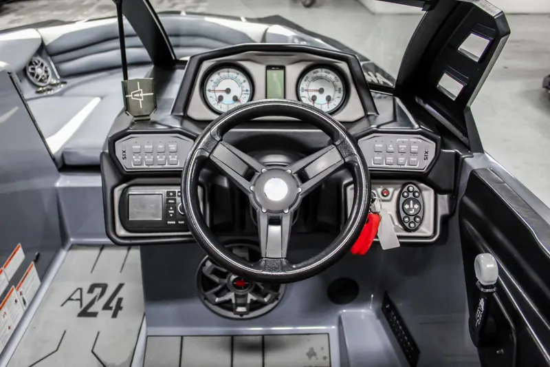 Slide: The Image of 2019 Axis A24 boat dashboard with steering wheel and control panel. - 13