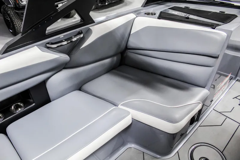 Slide: The Image of 2019 Axis A24 boat interior with gray and white cushioned seating. - 18