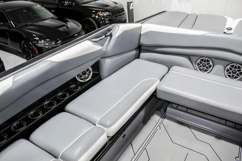 Slide: The Image of Luxurious interior of a 2019 Axis A24 boat with gray seating and cup holders. - 24