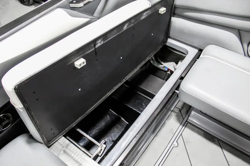Slide: The Image of 2019 Axis A24 boat interior storage compartment with open seat revealing storage space. - 25