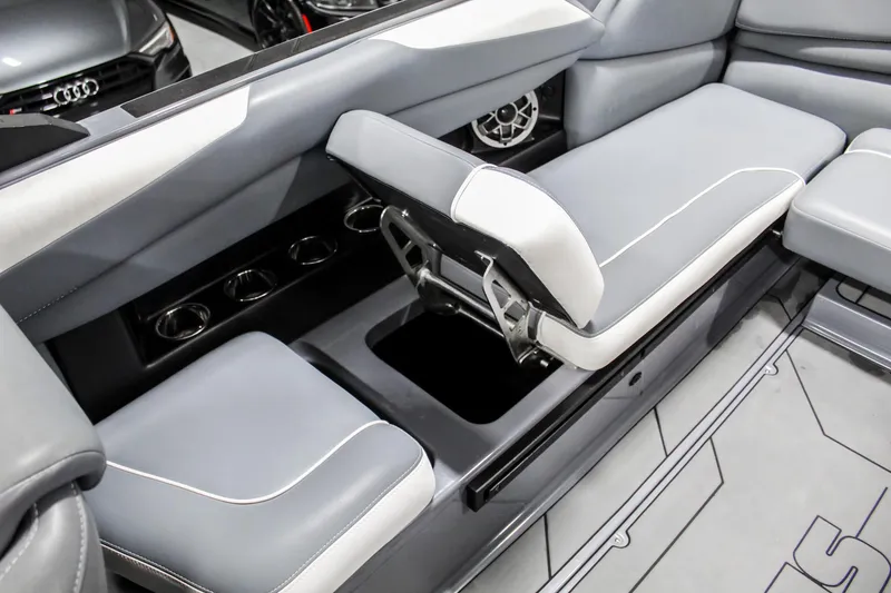 Slide: The Image of 2019 Axis A24 boat interior with gray seating and storage compartment. - 27