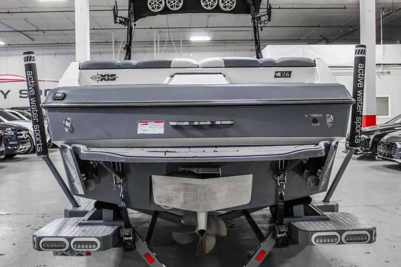 Slide: The Image of 2019 Axis A24 boat rear view in showroom, featuring sleek design and advanced wakeboarding features. - 3