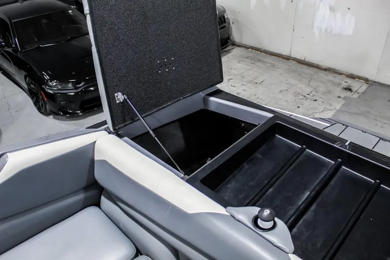 Slide: The Image of 2019 Axis A24 boat storage compartment with open lid, showcasing interior space. - 30