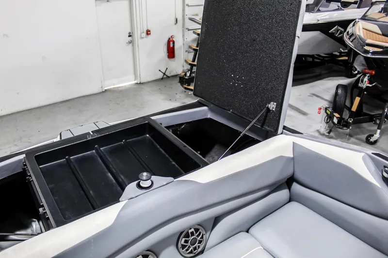 Slide: The Image of 2019 Axis A24 boat interior with open storage compartment and seating area. - 31
