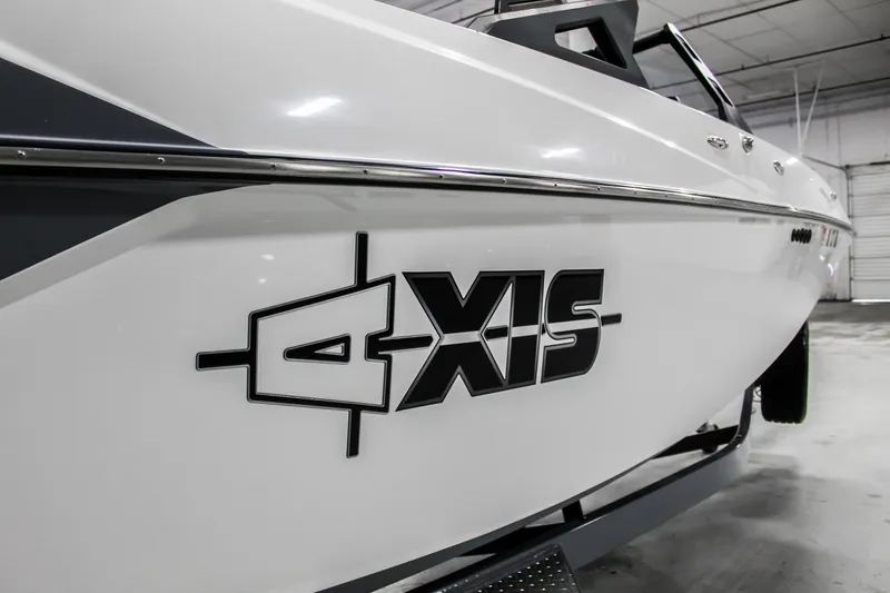 Slide: The Image of 2019 Axis A24 boat in a garage, showcasing sleek design and logo. - 34
