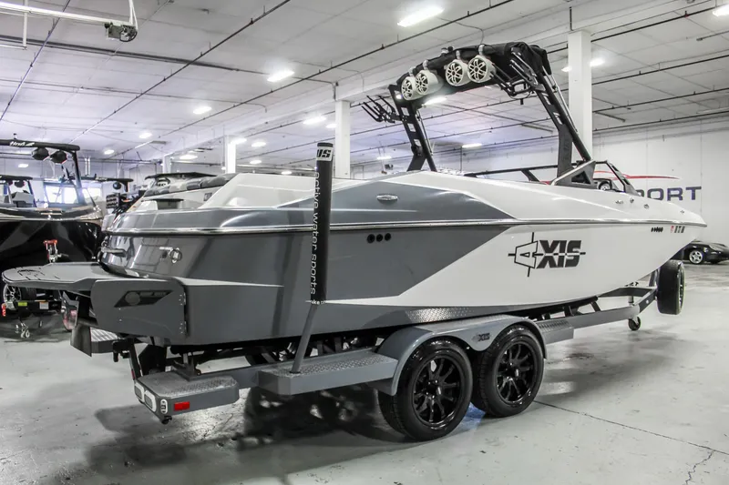Slide: The Image of 2019 Axis A24 boat in showroom, featuring sleek design and modern wakeboard tower. - 4