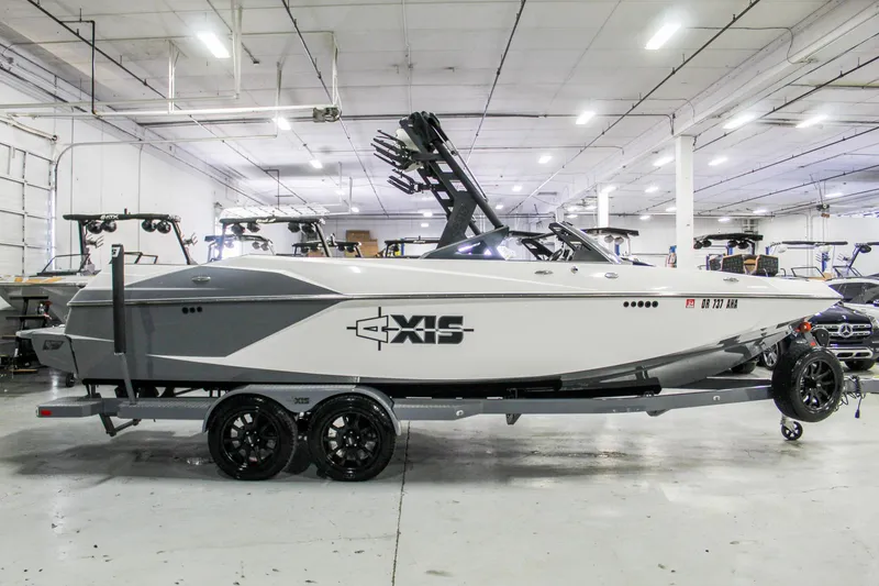 Slide: The Image of 2019 Axis A24 boat on trailer in indoor showroom. - 6