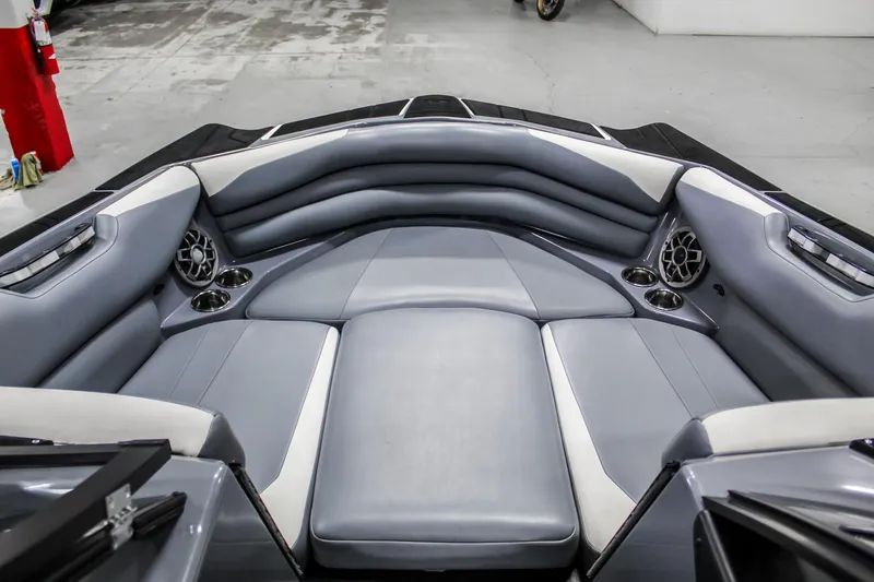 Slide: The Image of 2019 Axis A24 boat interior with gray seating and cup holders. - 8