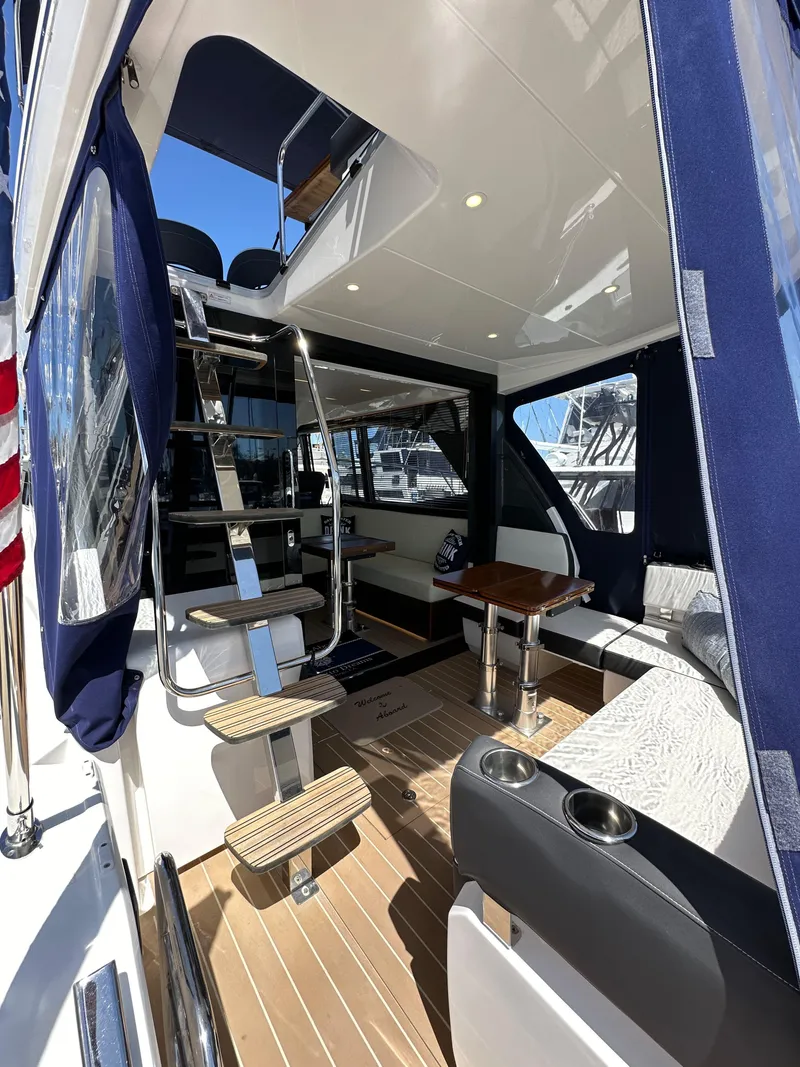 Slide: The Image of 2024 Bavaria R40 yacht interior with modern seating, table, and staircase. - 39
