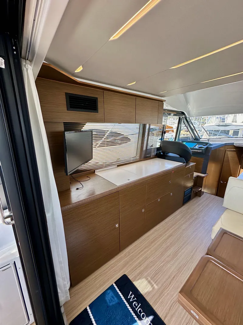 Slide: The Image of 2024 Bavaria R40 yacht interior with modern wood finish and sleek design. - 49