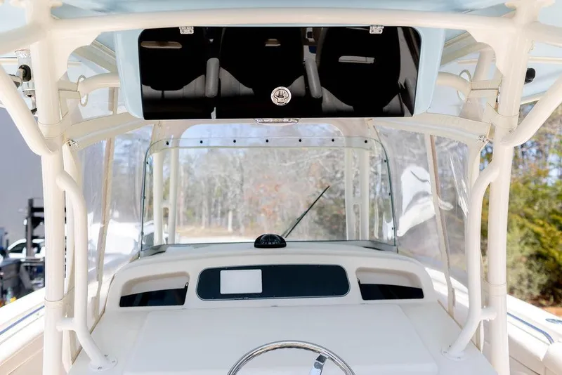 Slide: The Image of 2017 Grady-White Canyon 336 boat helm with steering wheel and windshield. - 16
