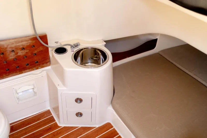 Slide: The Image of 2017 Grady-White Canyon 336 cabin interior with sink and storage drawers. - 17