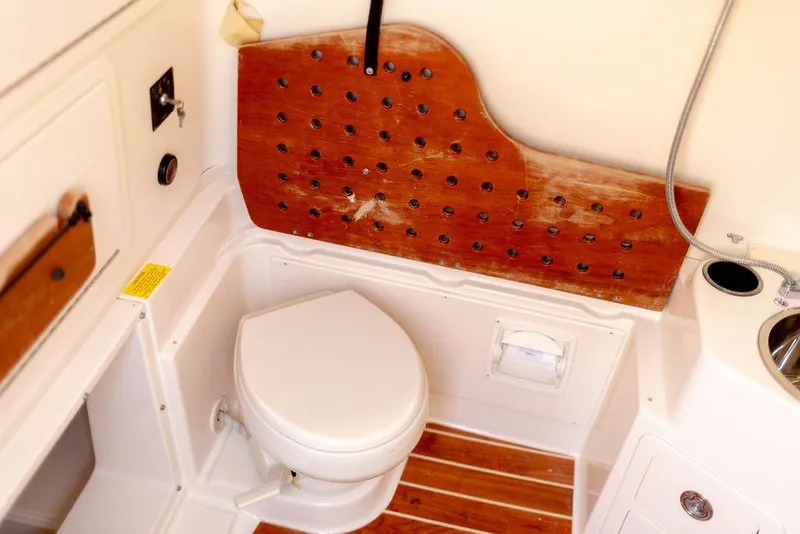 Slide: The Image of 2017 Grady-White Canyon 336 boat bathroom with wooden accents and modern fixtures. - 18