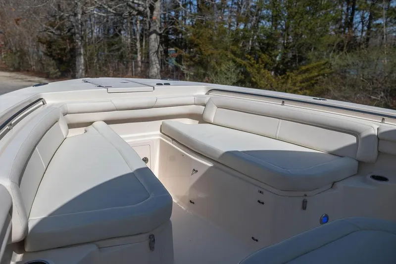 Slide: The Image of 2017 Grady-White Canyon 336 boat interior with cushioned seating and storage compartments. - 22