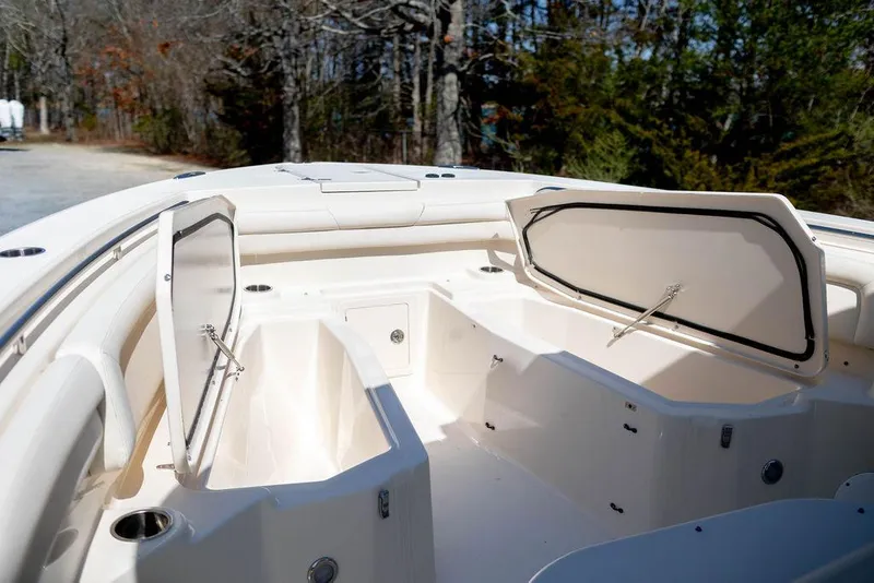 Slide: The Image of 2017 Grady-White Canyon 336 boat with open storage compartments, showcasing spacious interior design. - 23