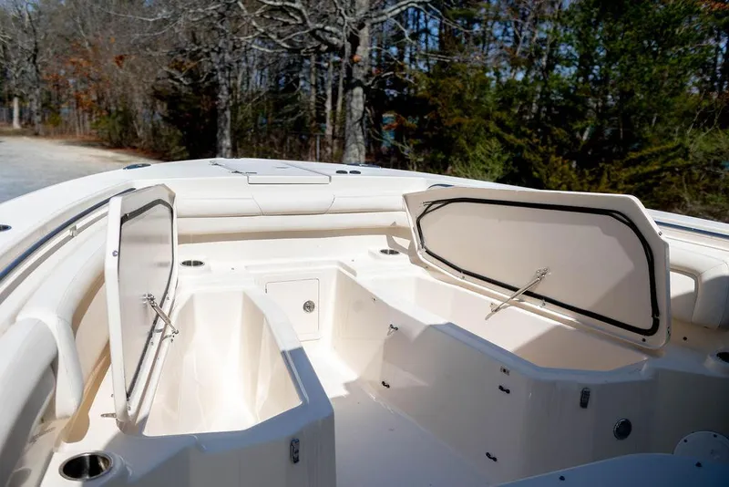 Slide: The Image of 2017 Grady-White Canyon 336 boat with open storage compartments, outdoor setting. - 24