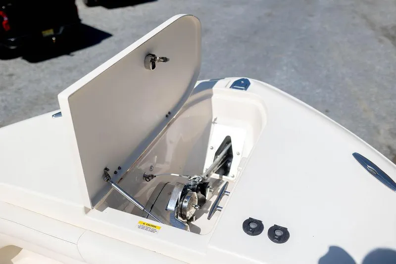 Slide: The Image of 2017 Grady-White Canyon 336 anchor locker with open hatch, showcasing anchor mechanism. - 25