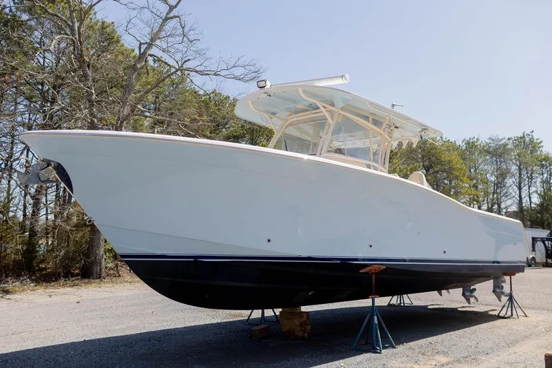 Slide: The Image of 2017 Grady-White Canyon 336 boat on stands, outdoors, side view. - 3
