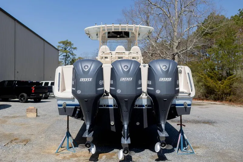 Slide: The Image of 2017 Grady-White Canyon 336 boat with triple Yamaha 300 engines, parked outdoors. - 5