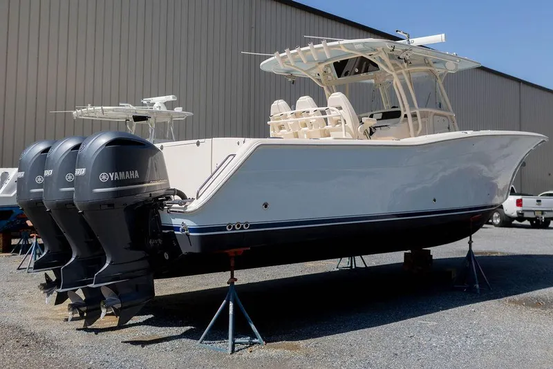 Slide: The Image of 2017 Grady-White Canyon 336 boat with triple Yamaha engines, displayed on stands. - 6