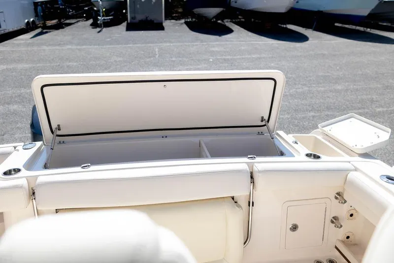 Slide: The Image of 2017 Grady-White Canyon 336 boat storage compartment open, showcasing spacious interior. - 7