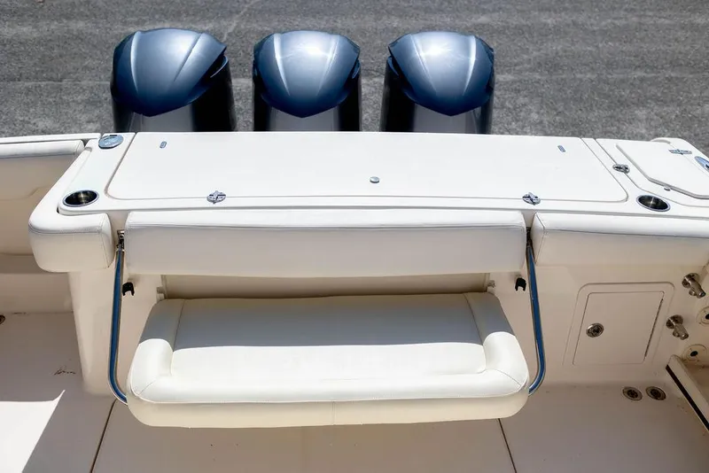 Slide: The Image of 2017 Grady-White Canyon 336 boat with triple outboard engines and foldable seating. - 9