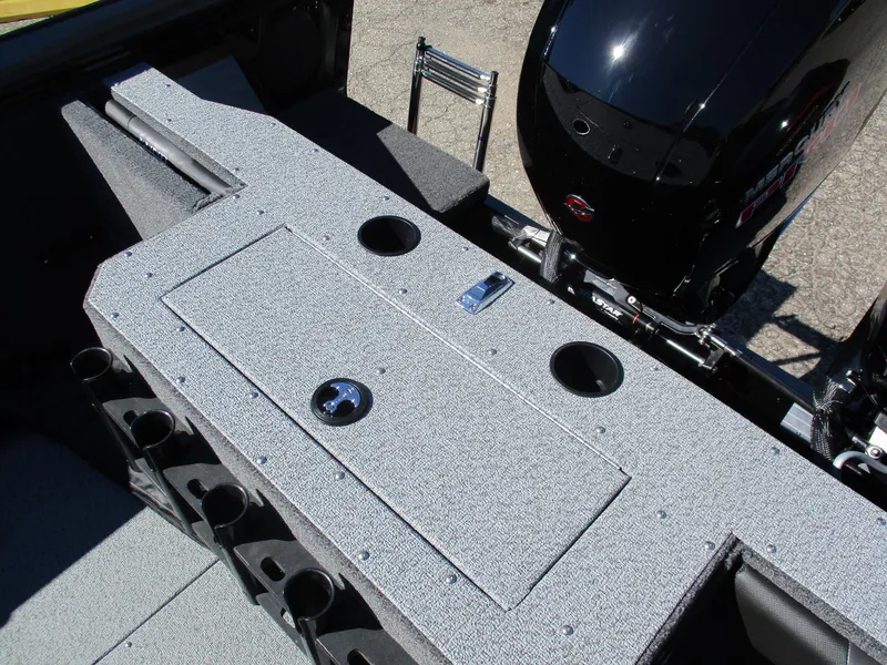 Slide: The Image of 2025 Lund 1875 Fisherman Sport boat interior with storage compartments and motor. - 10