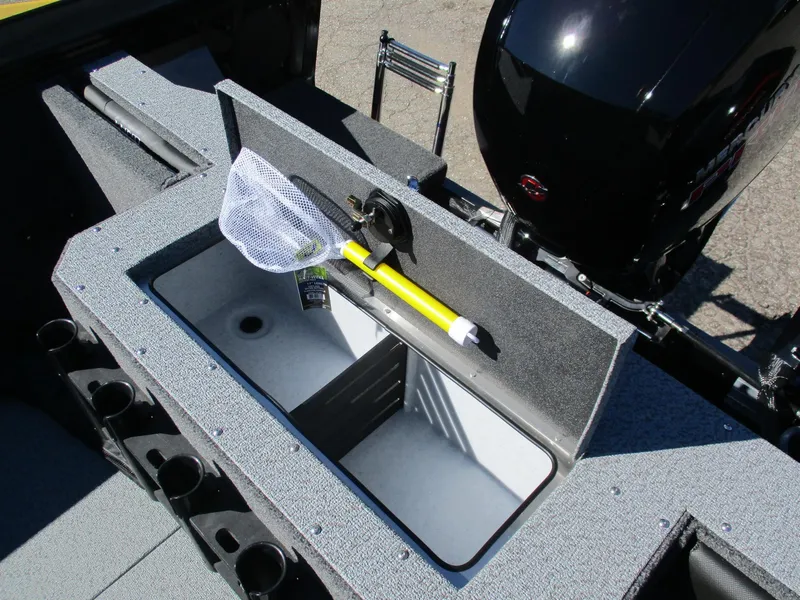 Slide: The Image of 2025 Lund 1875 Fisherman Sport boat interior with storage compartment and fishing net. - 11