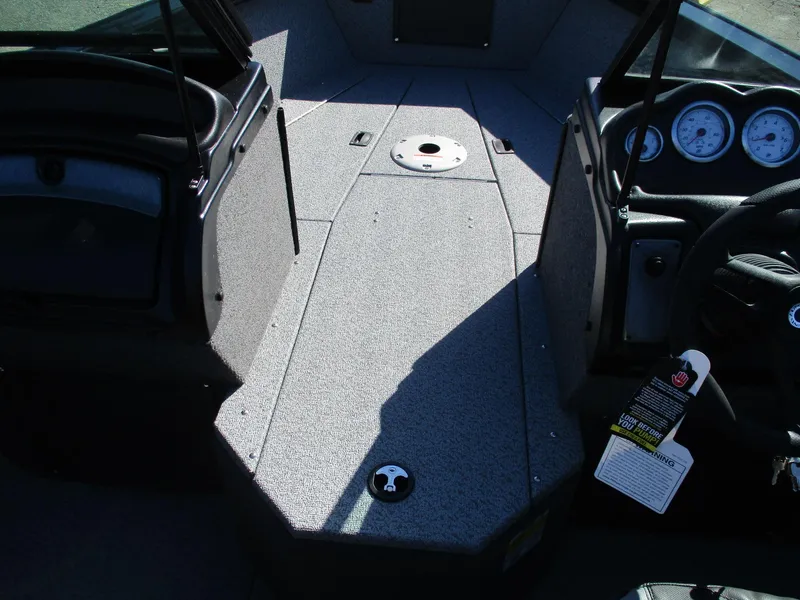 Slide: The Image of Interior of 2025 Lund 1875 Fisherman Sport boat, featuring dashboard and seating area. - 4