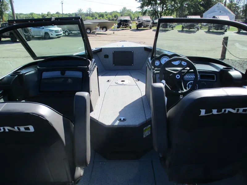 Slide: The Image of 2025 Lund 1875 Fisherman Sport boat interior with dual consoles and seating. - 7