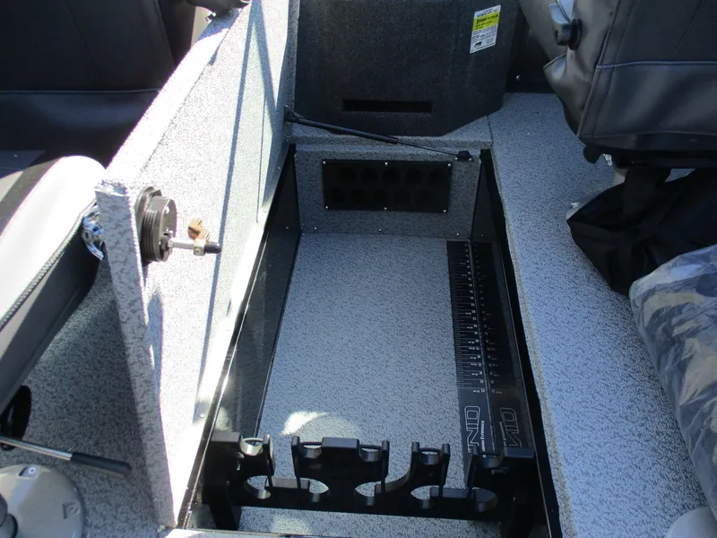 Slide: The Image of 2025 Lund 1875 Fisherman Sport interior storage compartment with rod holders and measuring ruler. - 8