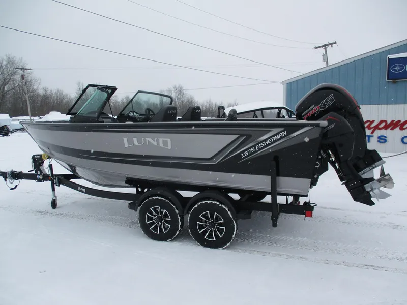 Slide: The Image of 2025 Lund 1875 Fisherman Sport boat on trailer in snowy setting. - 1