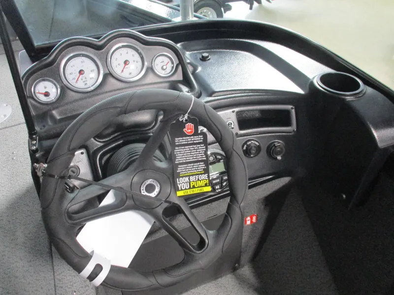 Slide: The Image of 2025 Lund 1875 Fisherman Sport dashboard with steering wheel and gauges. - 11