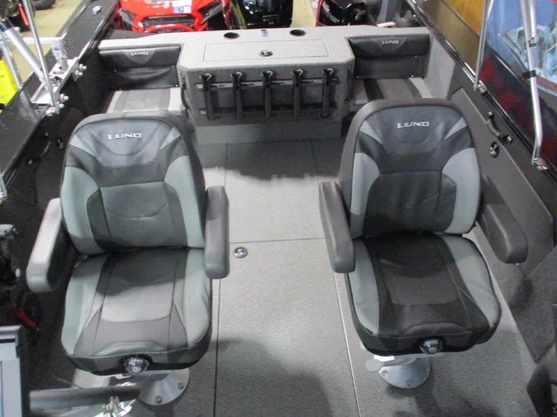 Slide: The Image of 2025 Lund 1875 Fisherman Sport interior with two cushioned seats and rod holders. - 6
