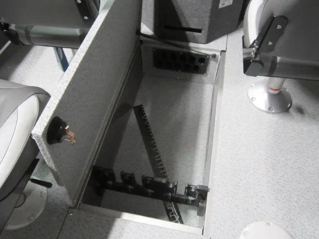 Slide: The Image of 2025 Lund 1875 Fisherman Sport boat interior storage compartment with open lid. - 7