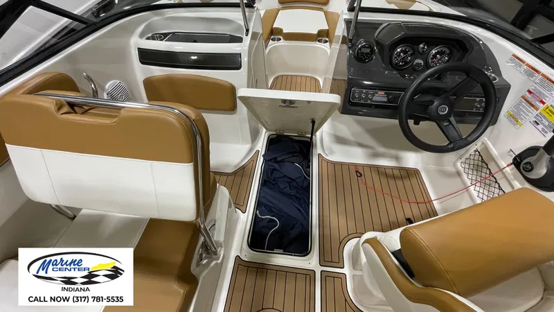Slide: The Image of 2019 Bayliner VR 5 boat interior with tan seats and wood-style flooring. - 10
