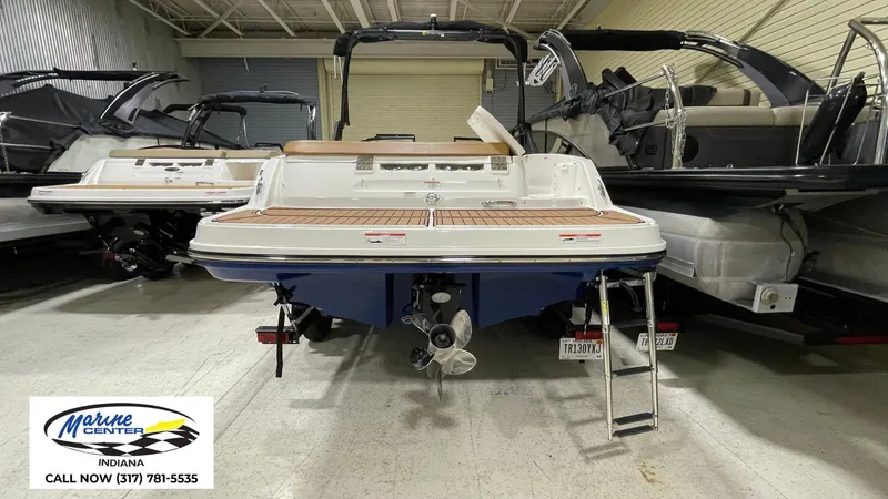 Slide: The Image of 2019 Bayliner VR 5 boat in showroom, rear view with ladder and propeller visible. - 14