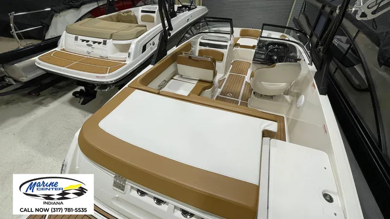 Slide: The Image of 2019 Bayliner VR 5 boat interior with tan and white seating, displayed at Marine Center Indiana. - 15