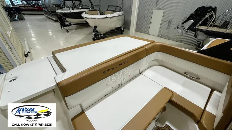 Slide: The Image of 2019 Bayliner VR 5 boat interior with tan and white seating at Marine Center Indiana. - 16