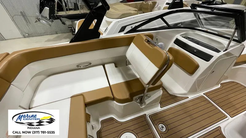 Slide: The Image of 2019 Bayliner VR 5 boat interior with tan and white seating, wood-style flooring. - 4