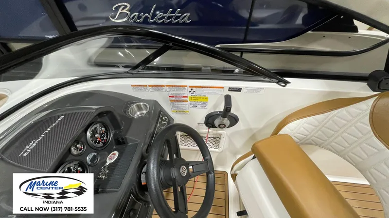 Slide: The Image of 2019 Bayliner VR 5 boat dashboard with steering wheel and controls, Marine Center Indiana contact info. - 7